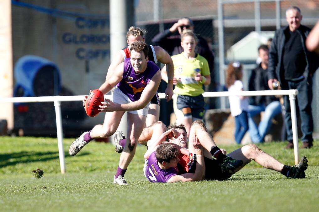 OFF AND RACING: Port Fairy's Colin Harwood leaves a tangle of players in his wake. Picture: Mark Witte