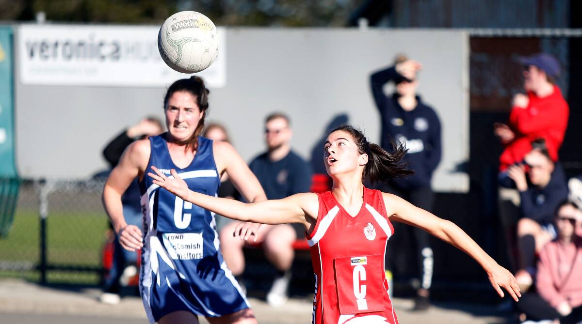 REACHING OUT: South Warrnambool's Isabella Rea attempts to catch the ball in front of Warrnambool's Sarah O'Keeffe. Picture: Mark Witte