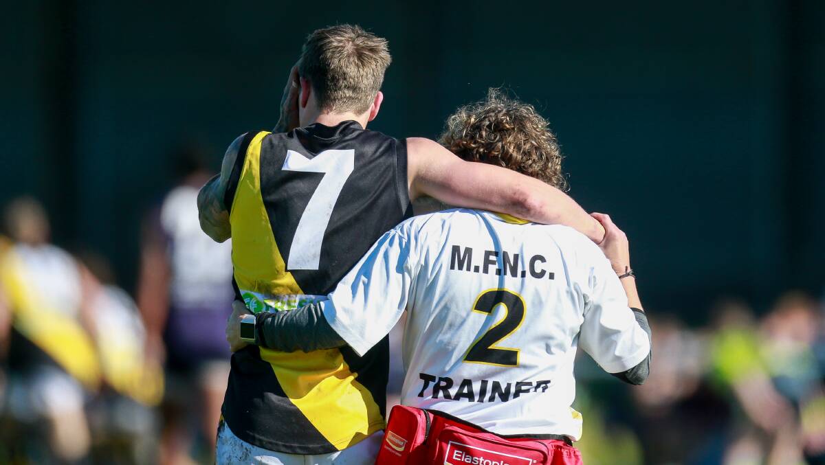 WAITING: Merrivale's Kyden Jarvis is helped from the ground on Saturday. Picture: Anthony Brady