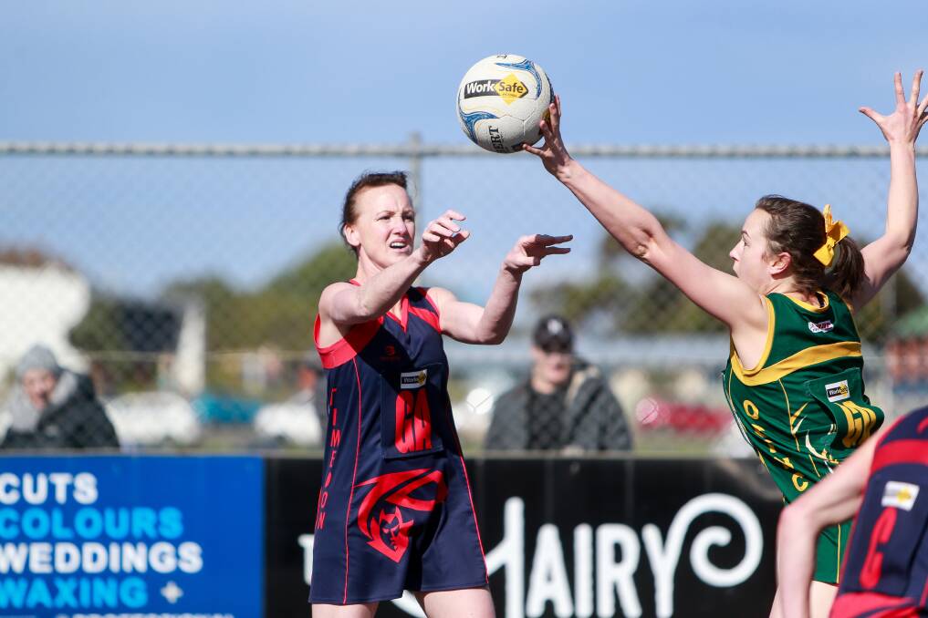 GOT IT: Old Collegians' Emily Porra was at her defensive best in the Warriors' elimination final win against Timboon Demons on Sunday, getting her hands to plenty of intercepts including this one against Hayley Plozza. Picture: Anthony Brady