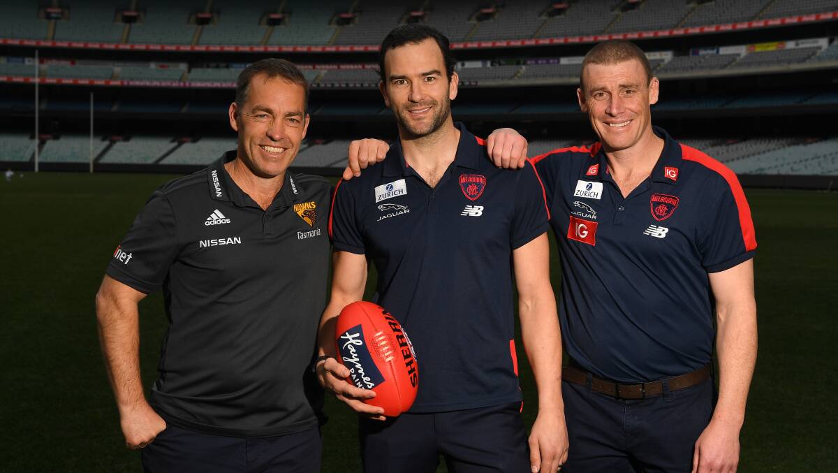 LEADERS: Hawthorn coach Alastair Clarkson and Demons mentor Simon Goodwin with Jordan Lewis after he announced his retirement. Picture: AAP Image/James Ross