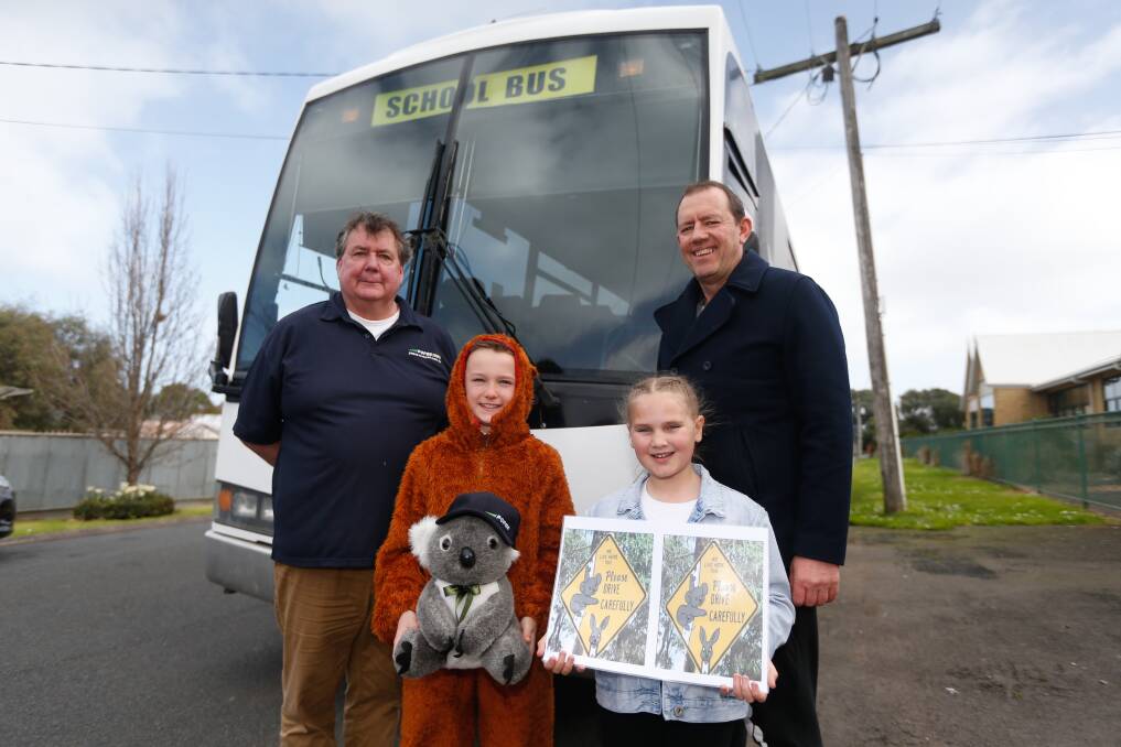 Bus Driver Peter Caton, David Boyd,11, Lori Willsher, 9, and principal Wes Allen talk about the adopt a koala program at the Allansford and District Primary School. Picture: Mark Witte
