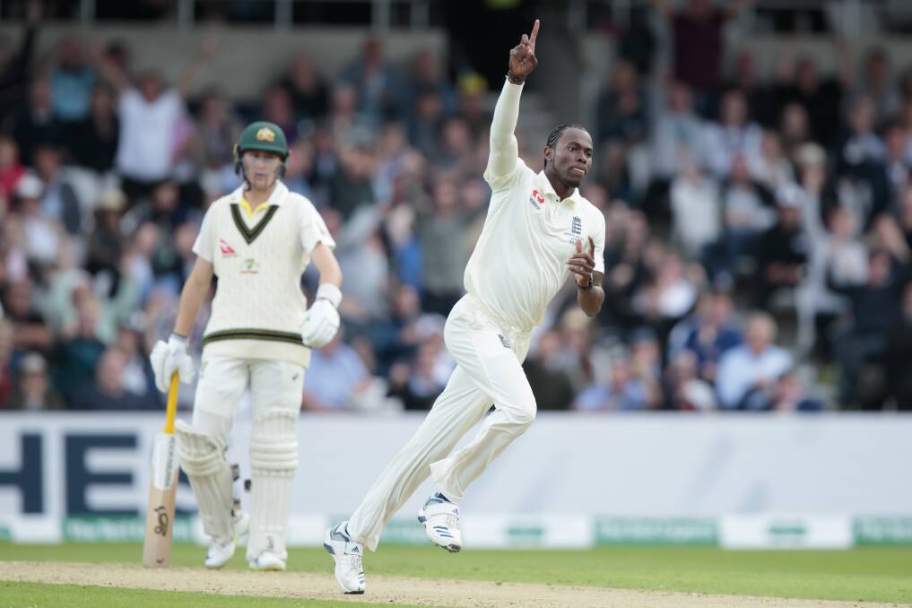 England's Jofra Archer celebrates after taking the wicket of Australia's David Warner.