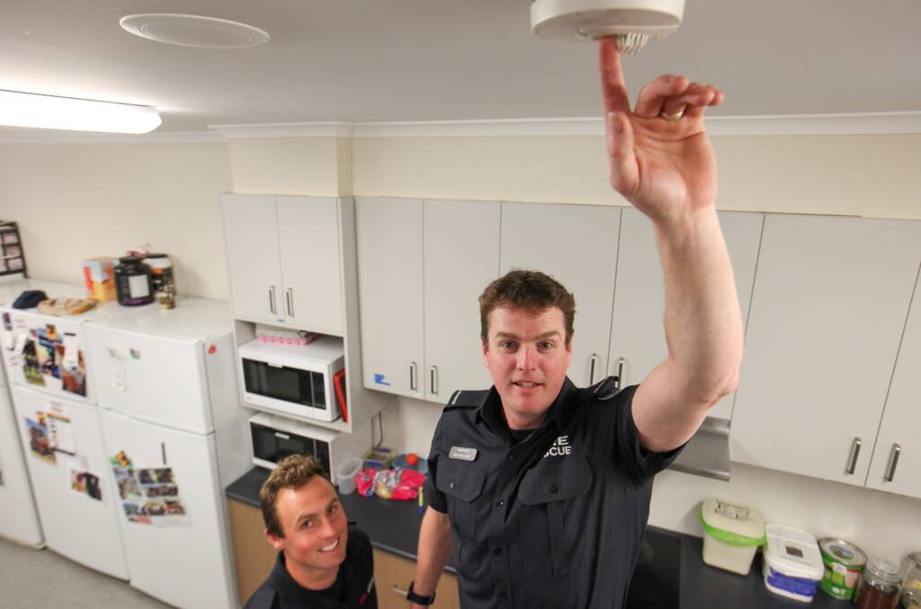 STAY SAFE: Warrnambool CFA Firefighters Lockie Kerney and Trev Moloney check the smoke detectors in the station break room. Picture: Rob Gunstone