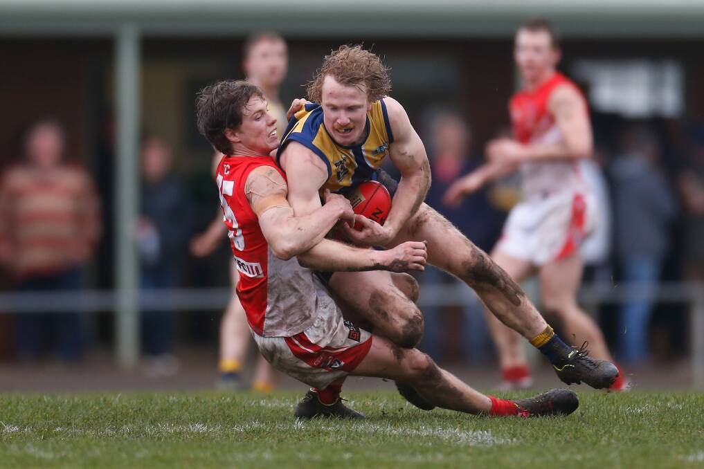 CRUNCH: North Warrnambool Eagles' Luke Wines gets tackled by South Warrnambool's Jock Blair. Picture: Mark Witte