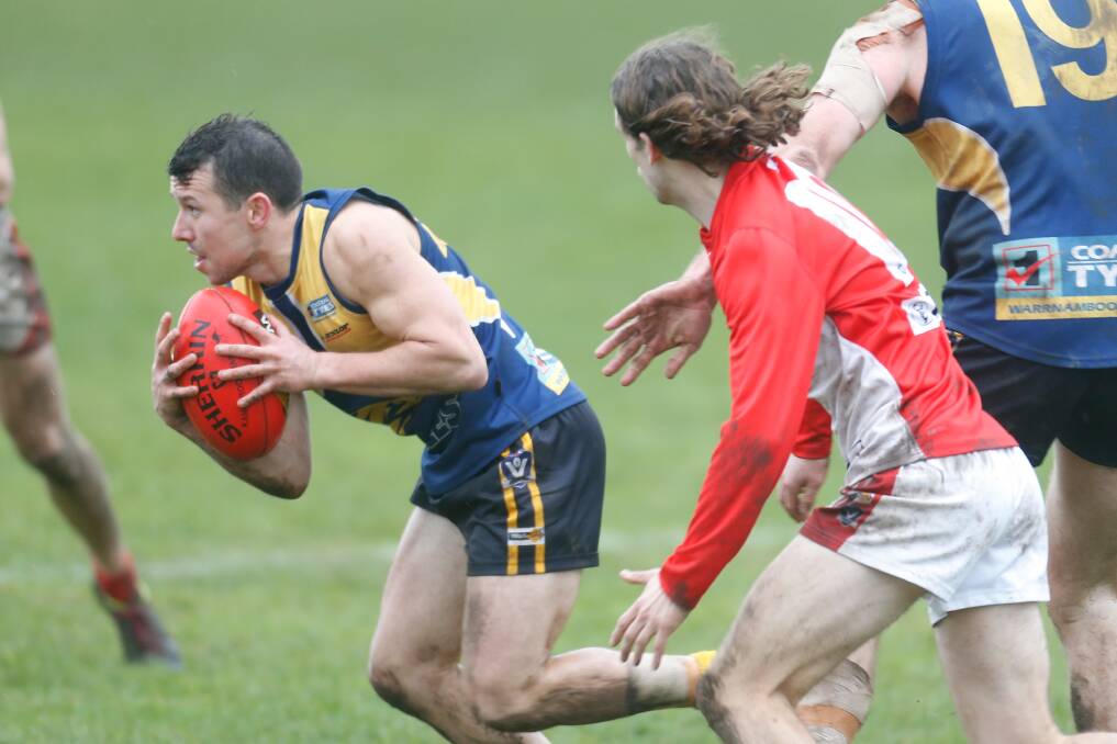 FORWARD PLAY: North Warrnambool Eagles' Jarryd Lewis shows his class in wet, slippery conditions at Bushfield on Saturday. Picture: Mark Witte