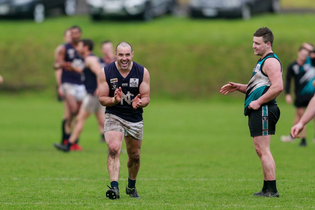 Good times: Nirranda's Peter McDowall and Kolora-Noorat's Mark Clissold after the final siren in the Blues' 2019 second semi-final win. Picture: Anthony Brady