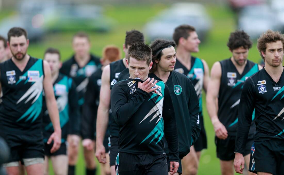 Tough day: A dejected Kolora-Noorat coach Ben Walsh leads his team off the ground after the loss. Picture: Anthony Brady