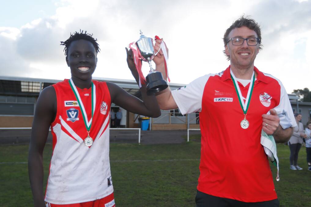 HERE IT IS: South Warrnambool's captain Mojwok Akoch and coach Sam Stevens receive the Hampden league under 16 premiership cup in August. Picture: Mark Witte