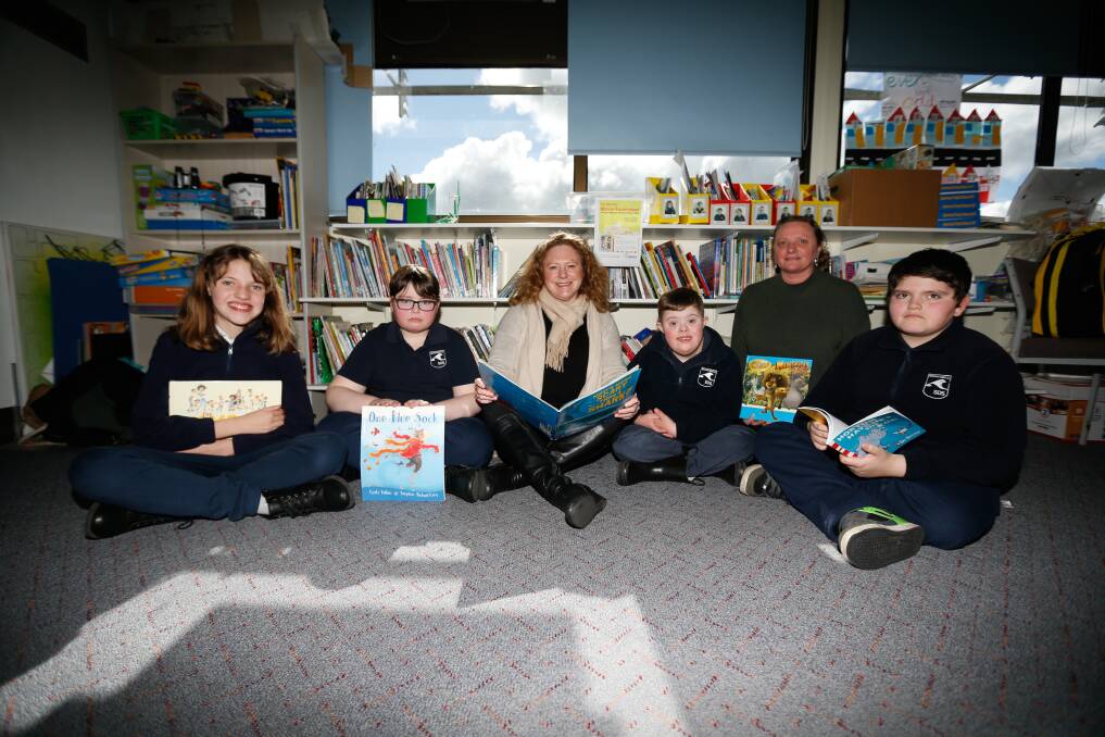 BOOK LOVERS: Students Faye Carty, Cody Grandell, SDS strengthenign committee chair Kylie Gaston, Ryan Crispe, assistant principal Jo Roche and Brodie Hughes. Picture: Mark Witte