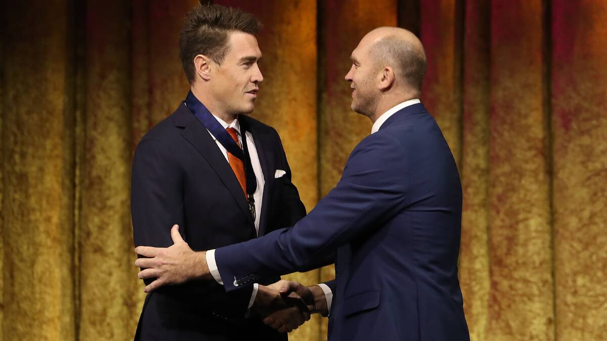 'GOOD JOB': Jeremy Cameron is presented with the Coleman Medal by Melbourne legend David Neitz at the 2019 All Australian Awards. Picture: Robert Cianflone/Getty Images