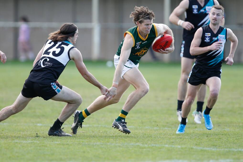 In action: Old Collegians' Daniel Weel gets away from Kolora-Noorat's George OSullivan in the 2019 WDFNL preliminary final. Picture: Mark Witte