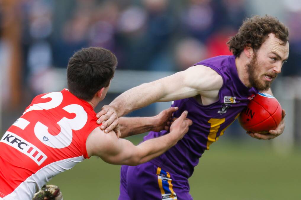 OUT OF MY WAY: Port Fairy's Lachlan Glare fends off South Warrnambool's Heath Brennan in the elimination final. Picture: Morgan Hancock