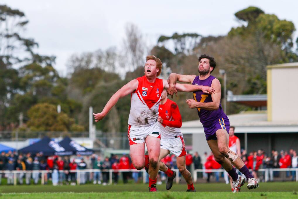 BIG MEN BATTLE: South Warrnambool's Manny Sandow and Port Fairy's Sandy Robinson compete in the ruck as the large finals crowd watches on. Picture: Morgan Hancock