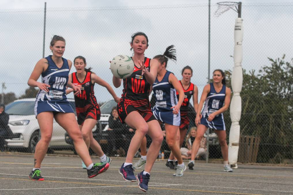 NIMBLE: Cobden's Amy Hammond takes the ball on the move against Warrnambool. Picture: Rob Gunstone