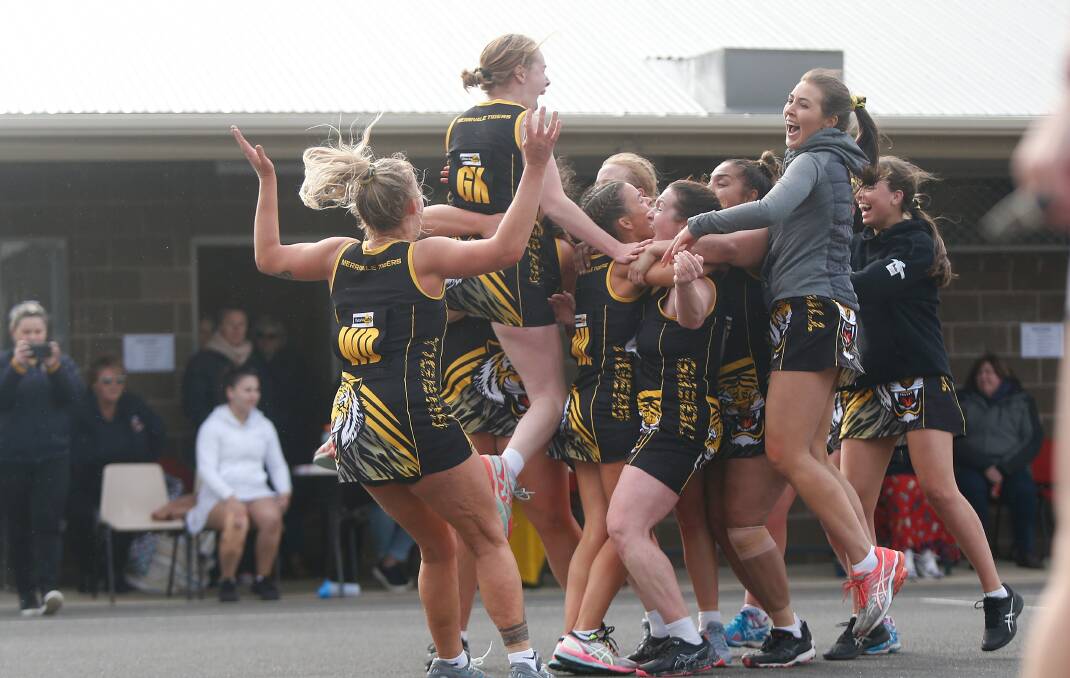 PARTY TIME: Merrivale's Cloe Pulling jumps onto her team mates after winning the grand final against Nirranda. Pictures: Mark Witte