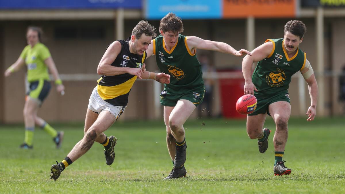 Clarity on footy's return: Merrivale's Trent Murphy sprints towards the ball alongside Old Collegians' Tayne McDonald and Jacob Malone in 2019. The state government has announced when full-contact training and competition can commence. Picture: Morgan Hancock