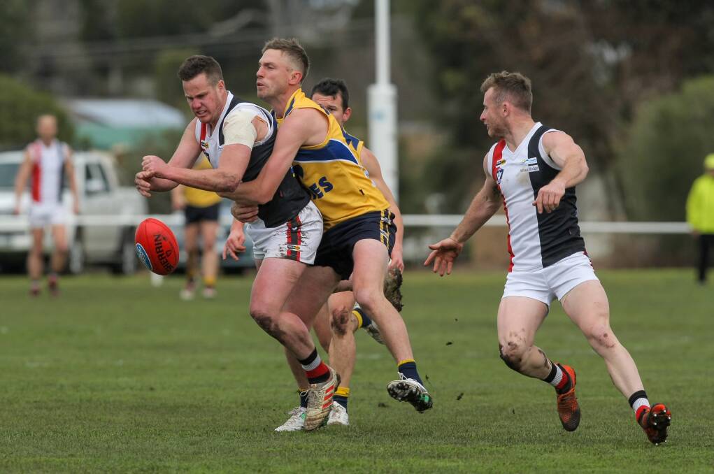 WRAPPED UP: North Warrnambool Eagles' Billie Smedts tries to stop the run of Koroit's Liam Hoy in the second semi-final. Picture: Rob Gunstone