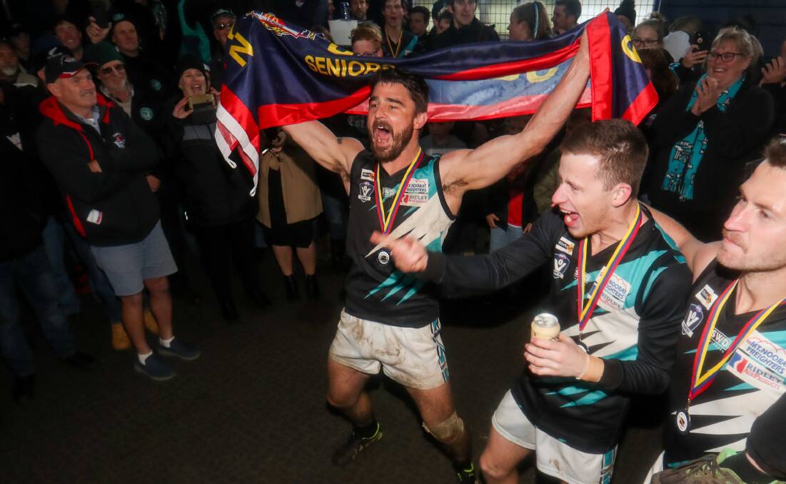 Party time: Kolora-Noorat's Brad Johnson walks into the rooms with the flag following the 2019 premiership victory. Picture: Morgan Hancock