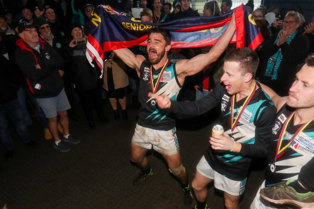 WE'RE NUMBER ONE: Kolora-Noorat's Brad Johnson walks into the rooms with the flag following the Power's premiership victory. Picture: Morgan Hancock