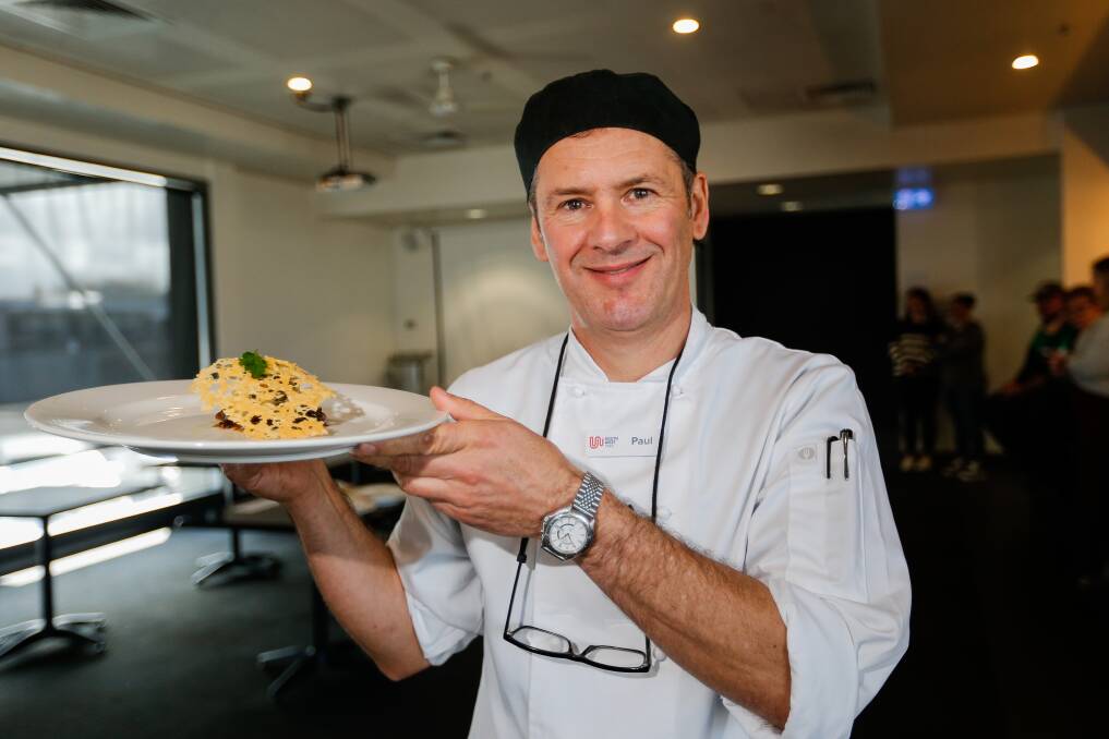 Judge Paul McLeod holds up a gratin stack made by a contestant at the WorldSkills event in Warrnambool. Picture: Anthony Brady