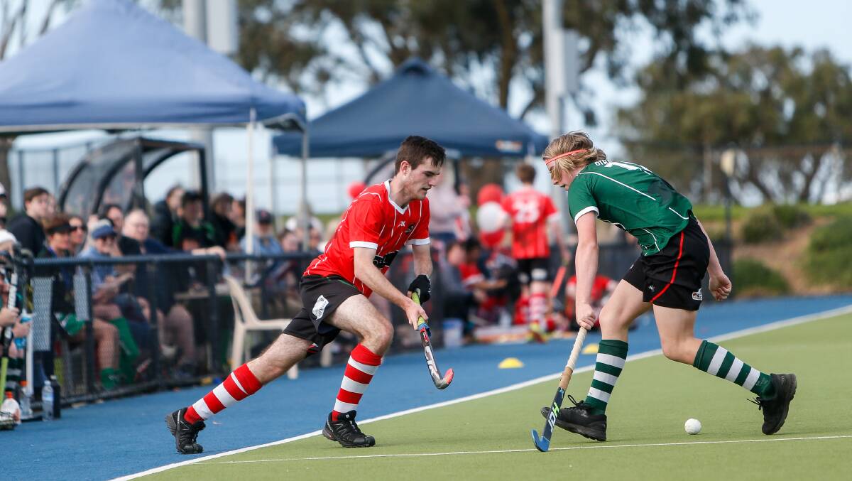HALTED: Buccaneers player Hayden Gibblin and Pirates player Darcy Nelson-Hill during the Warrnambool and District Hockey Association men's grand final. Picture: Anthony Brady