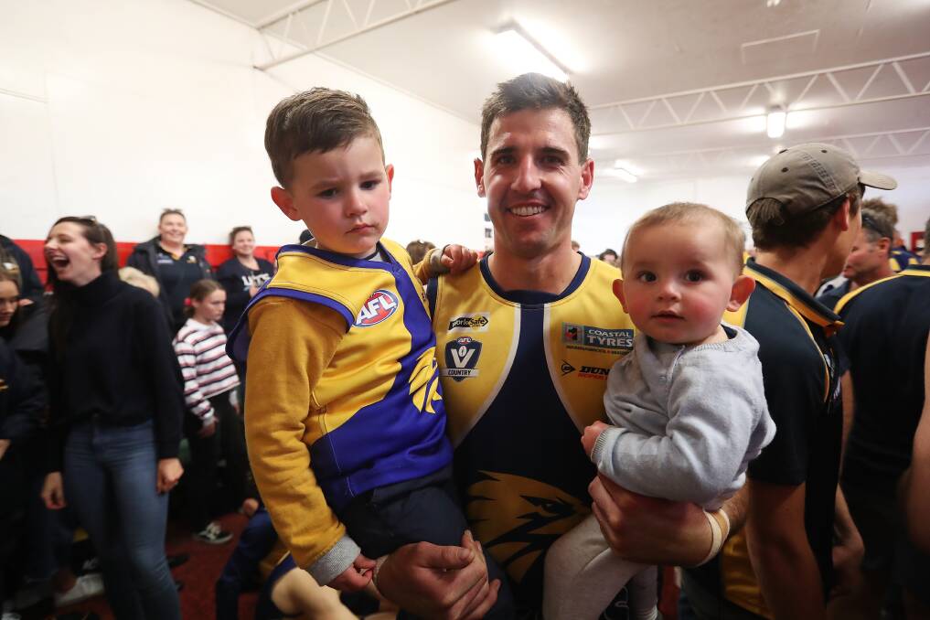 FAMILY MEMORIES: North Warrnambool Eagles' Tom Batten with children Oliver, 3, and Arthur,1, in the rooms post-game. Picture: Mark Witte