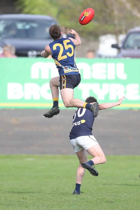 ALMOST: North Warrnambool Eagles' Thomas O'Leary goes to take a screamer over Warrnambool's Wil Fleming in the preliminary final. He didn't reel in the mark but will go for another leap if the opportunity presents itself in the grand final. Picture: Mark Witte