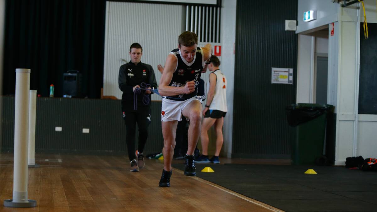 Honing skills: Toby Mahony is mentored by Rebels high performance manager Russell Rayner before the AFL state combine. Picture: Mark Witte