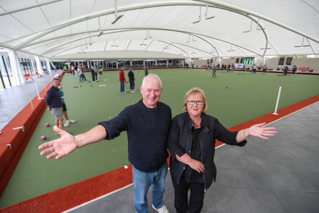 OPEN FOR BOWLS: Board chair Ray Cooknell and City Memorial Bowls Club general manager Julie Dosser with the first bowlers under the new roof. Picture: Morgan Hancock