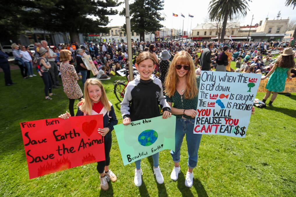 Civil disobedience: Emerson White, 12, Ilah Schmutter, 12, and Lily Schmutter, 16, show off their signs. Picture: Morgan Hancock