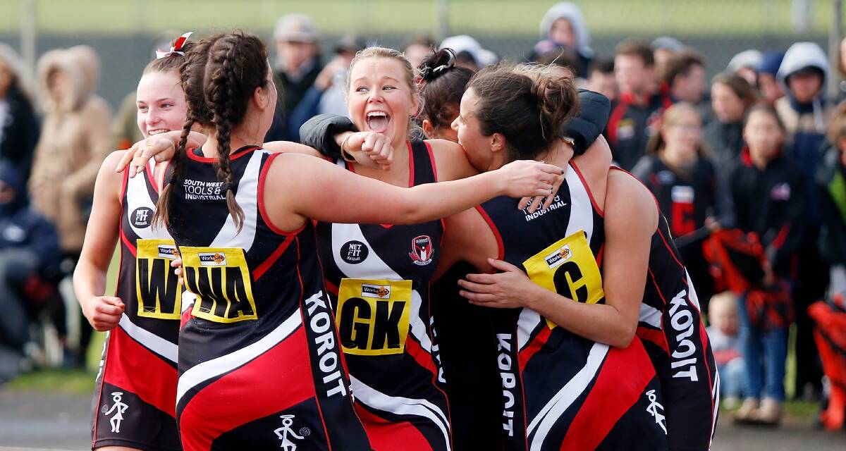 SWEET VICTORY: Koroit defender Emily Batt screams in excitement and embraces her teammates after winning her second open netball premiership in three years. Pictures: Mark Witte