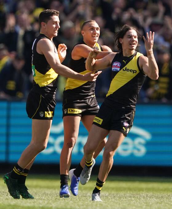 Celebration: Richmond's Daniel Rioli is congratulated by teammates Shai Bolton and Jason Castagna after kicking a goal during the grand final. Picture: Scott Barbour, The Age