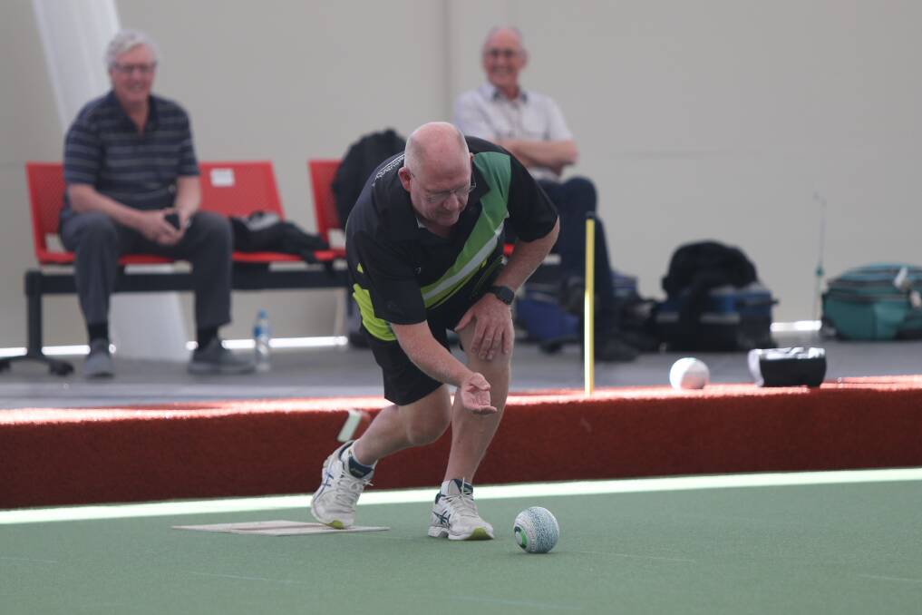 Leader: Australian national bowls coach Steve Glasson rolls up on the new greens. Picture: Mark Witte