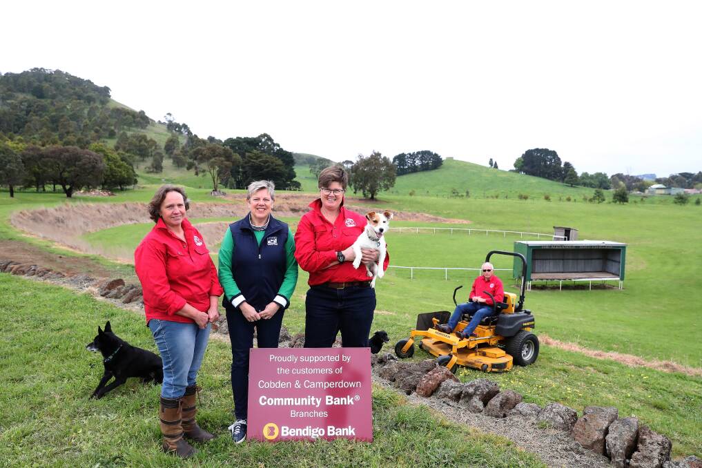 Show time: Camperdown show committee members Cheryl McMahon, Jennifer Downie and Amanda Manifold, with Olive the dog, and Philip Downie (background) are getting the grounds ready for the Camperdown Show. Picture: Mark Witte