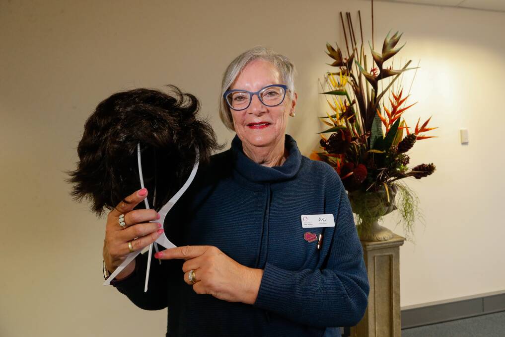 Helping patients: Judy Conn with one of the wigs. Picture: Anthony Brady