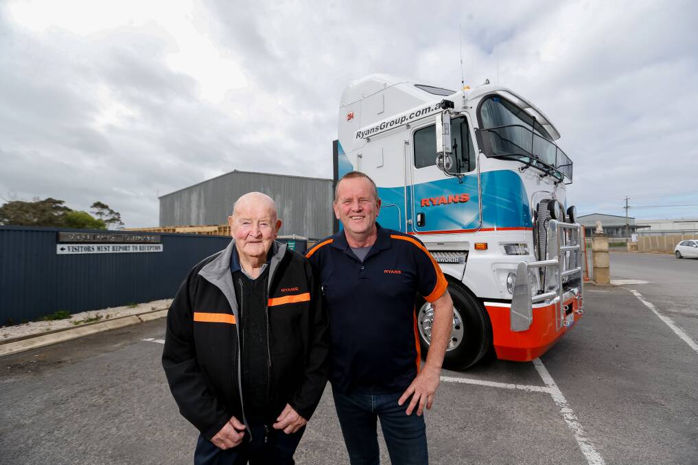 NATIONAL STAGE: Father-son owners of Ryans Transport Frank and Graham Ryan with two new trucks at the Warrnambool depot. The business started depots interstate this year. Picture: Anthony Brady