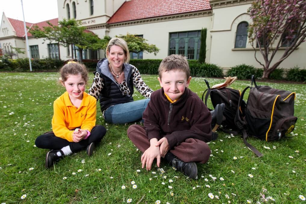 Overjoyed: Warrnambool Primary School prep student Clancey Greene, 6, and grade one student Jett Greene, 7, pictured with their mum Catherine Fitzgerald, will access before-school care from the start of the 2020 school year. Picture: Rob Gunstone