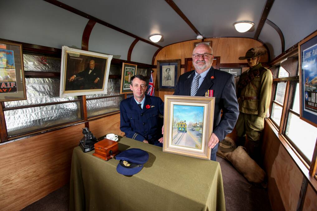 Recruiting station: Historian David McGinness with Terang RSL president Steve Bloxham holding the tram painting donated by Sam and Kay Wiltshire. Picture: Rob Gunstone