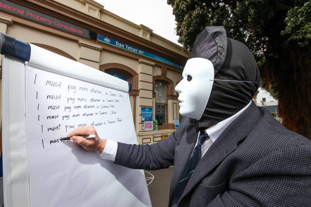 Not happy Dan: An Extinction Rebellion protester writes lines in detention on behalf of Federal education minister Dan Tehan in Warrnambool. Picture: Rob Gunstone
