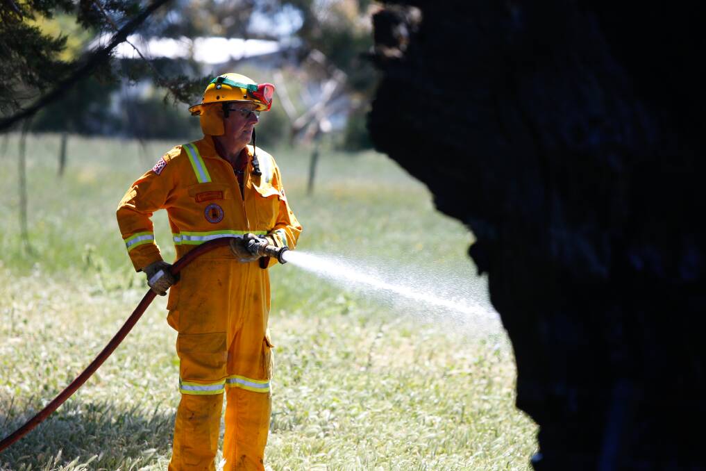 A firefighter helps to contain a fire in Purnim last year. Picture: Mark Witte