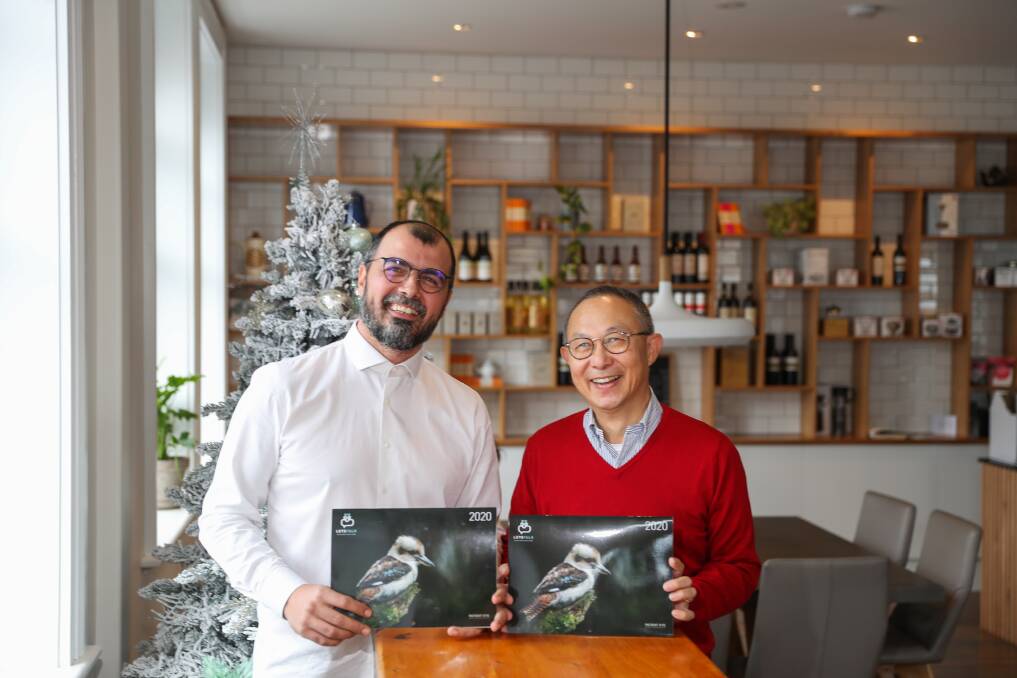 Engin Torun and Perry Cho show off the calendar they produce as a fundraiser for Let's Talk foundation. Picture: Morgan Hancock