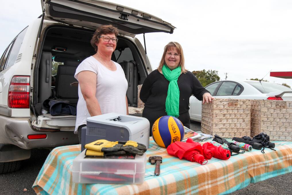 Everything must go: Heather Haberfield and Sandra Lee Ludeman get ready for the car boot sale at Naringal Baptist Church.