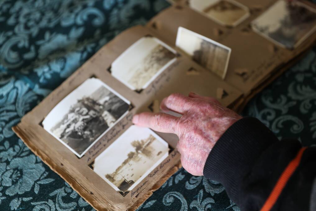 TIME CAPSULE: Wally Robertson, 96, shows off old photos in his collection. He was one of the original settlers at Tarrone. Picture: Morgan Hancock