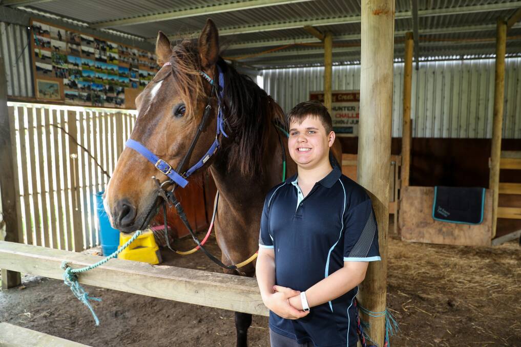 Ashley Holmes, 14, of Warrnambool Special Developmental School poses with his favourite horse. Picture: Morgan Hancock
