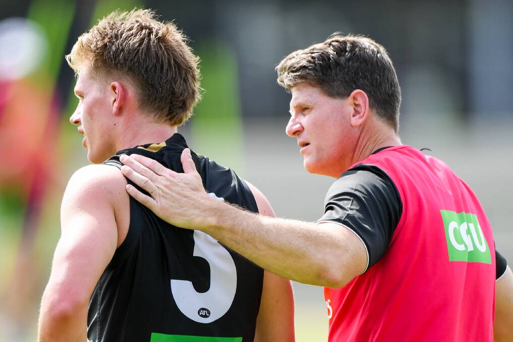 ADVICE: Brownlow Medallist-turned-assistant coach Robert Harvey embraces Jay Rantall during a Collingwood training session. Picture: Morgan Hancock