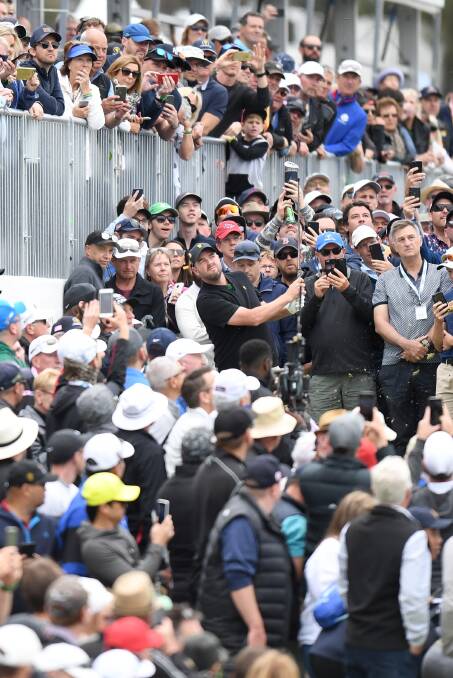 SPOT THE GOLFER: Crowds clear a gap for Marc Leishman to hit the ball on the 10th hole on the opening day of Presidents Cup action on Thursday. Picture: Morgan Hancock