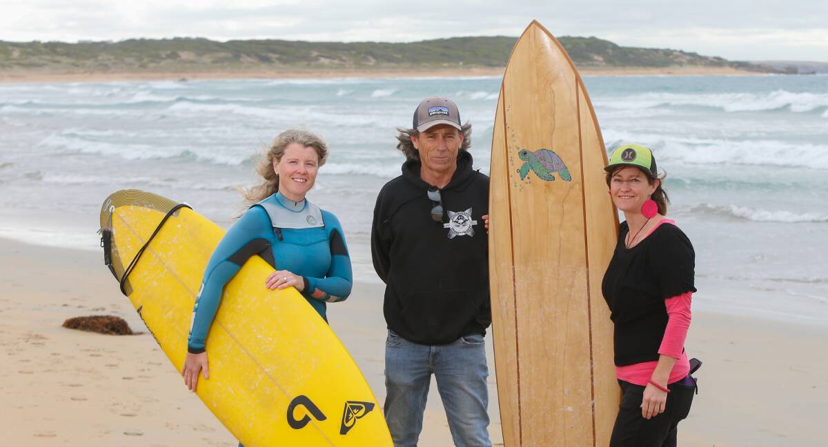 Waiting for waves: Warrnambool boardriders Kylie Palmer, Baz Law and Michelle Lyons are ready to go for the Paddle out for Pink surfing competition. Picture: Mark Witte