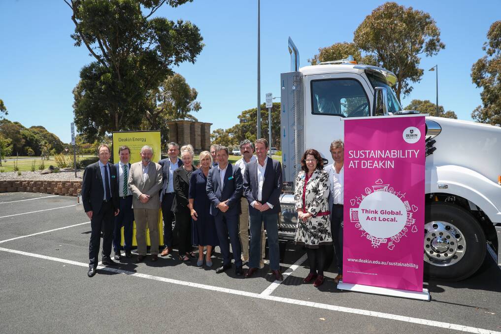 Researchers, south-west political leaders and industry representatives pose for a photo with a truck at Warrnambool's Deakin University campus. Picture: Morgan Hancock