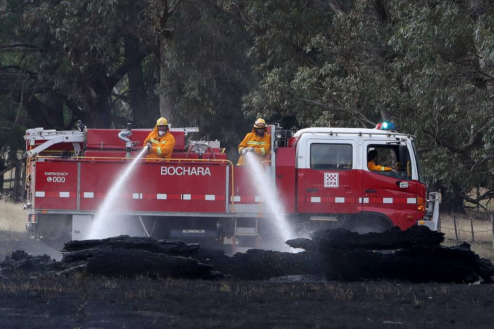 Fire: CFA members work on a bushfire on a farm at Dunkeld. Picture: Morgan Hancock